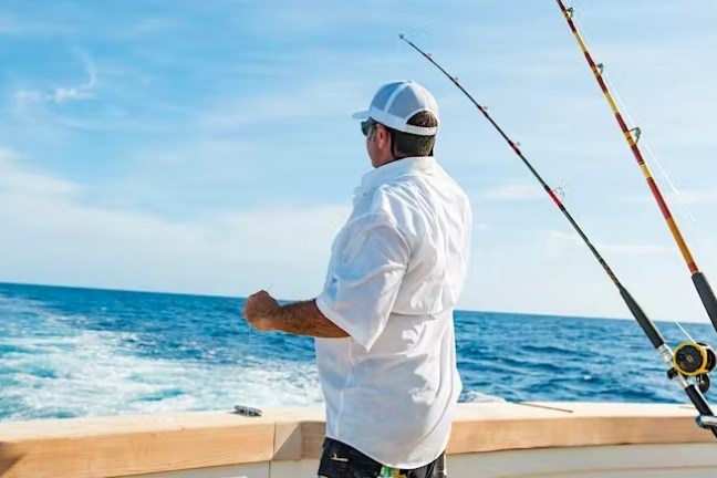 a man standing next to a body of water